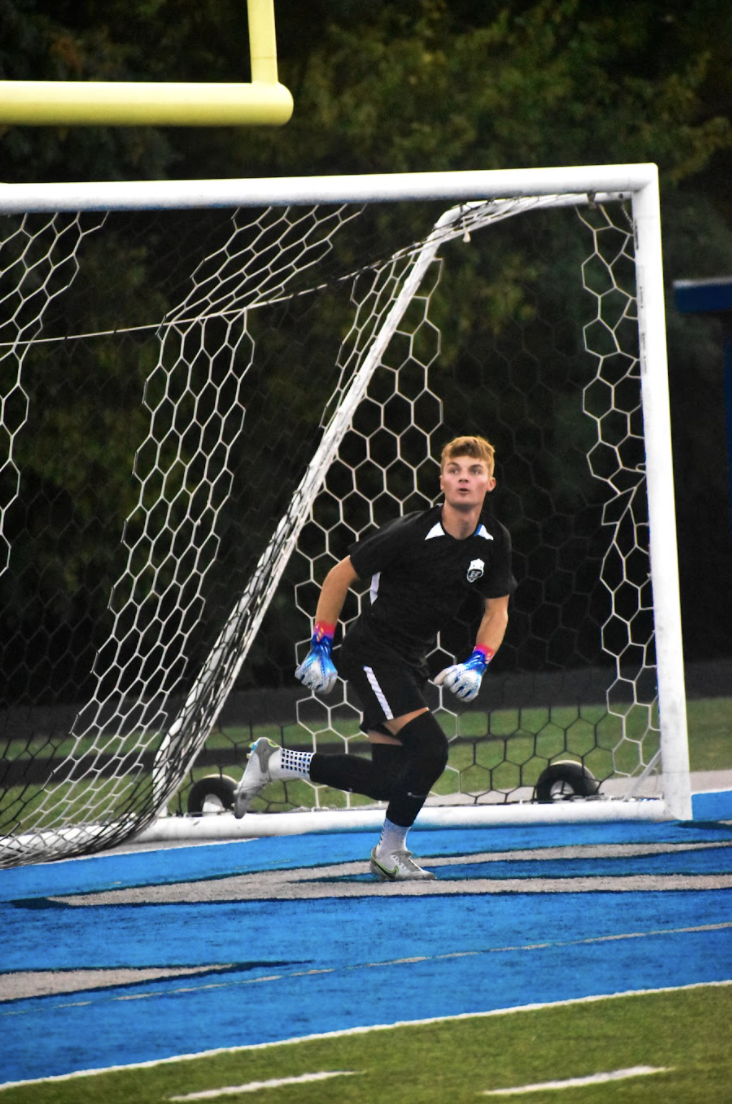 Sam Lang (12) warms up for goalie.